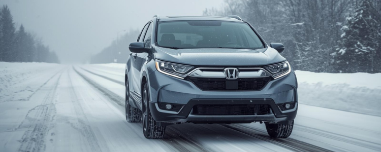 Honda SUV driving on a snowy road, demonstrating all-wheel drive traction and winter control