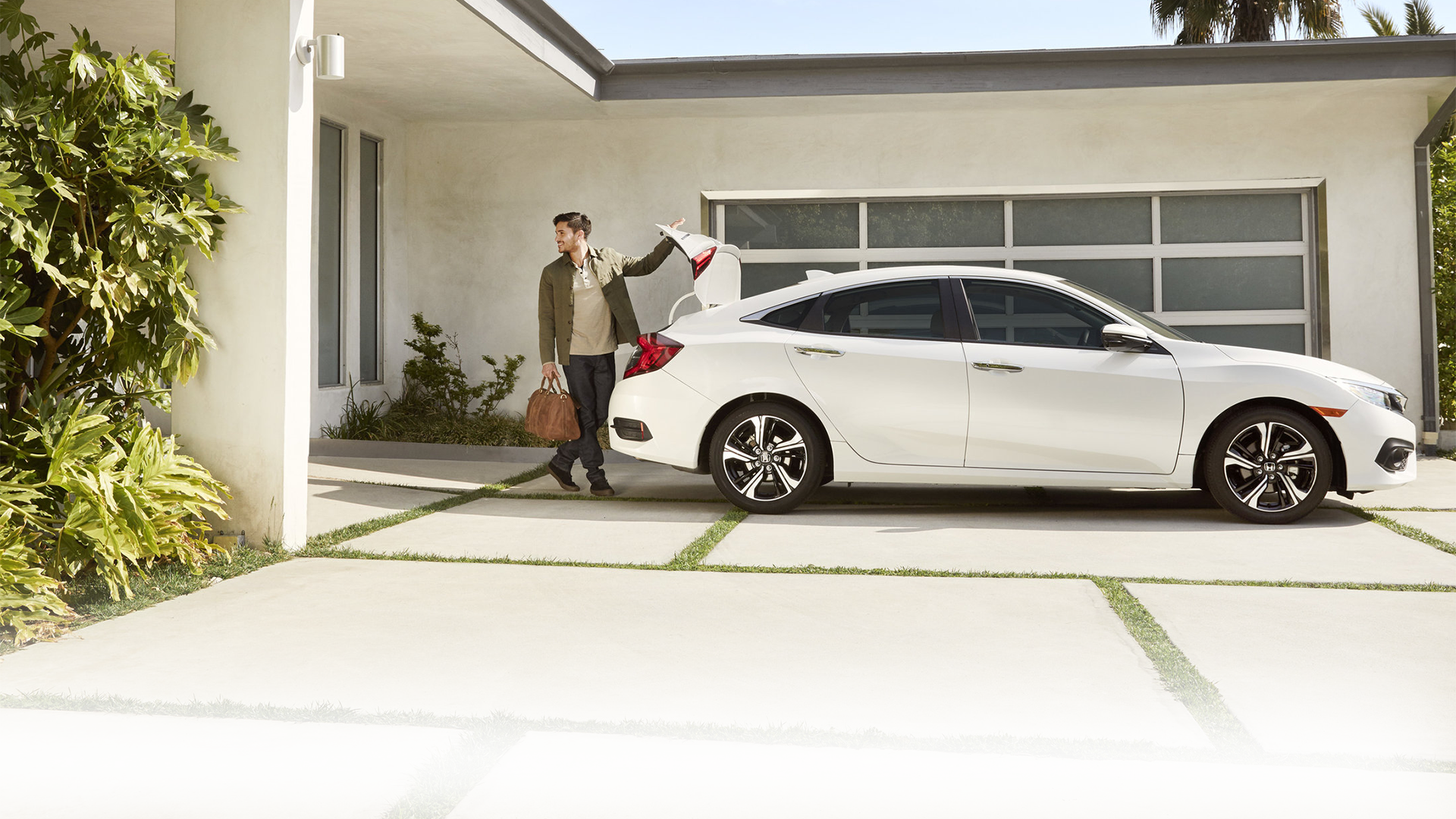 image of a man closing a trunk on a car