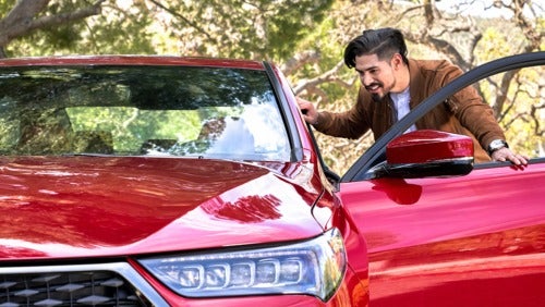 image of a man looking in a car