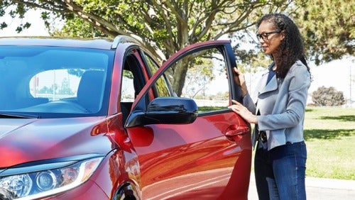 image of a woman looking in a car