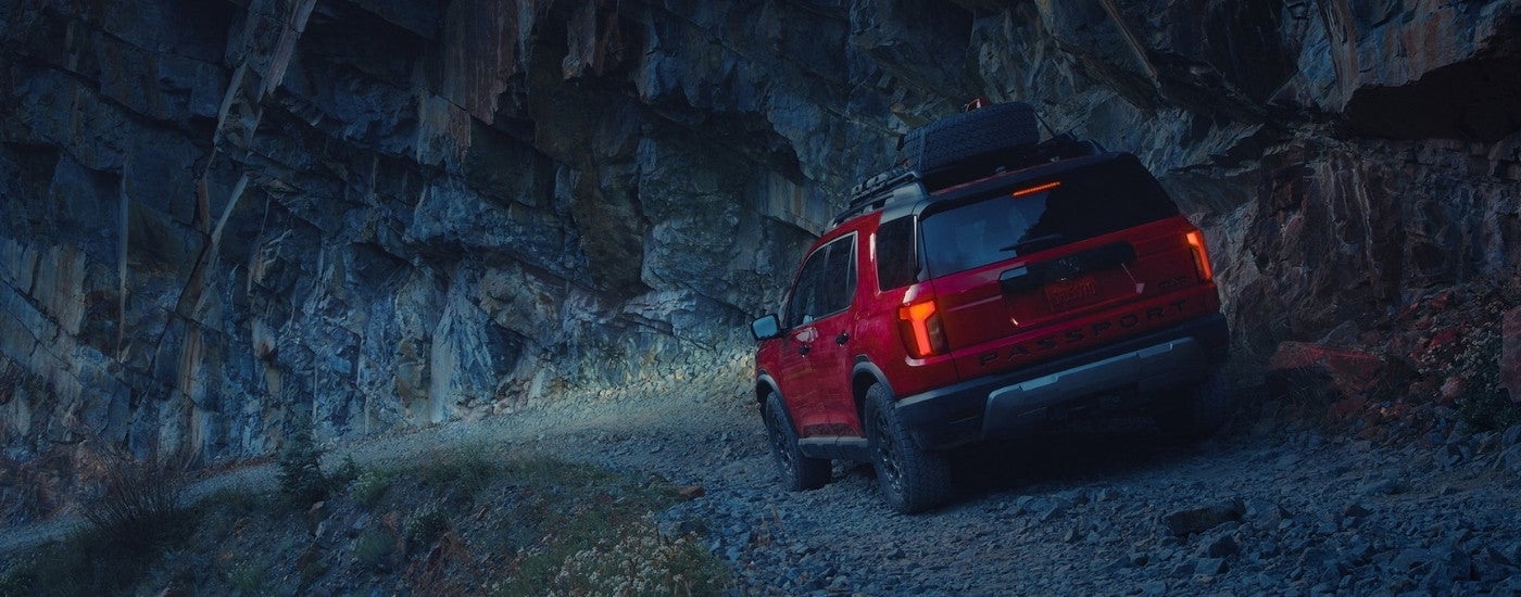 Red 2026 Honda Passport TrailSport Elite off-roading at night
